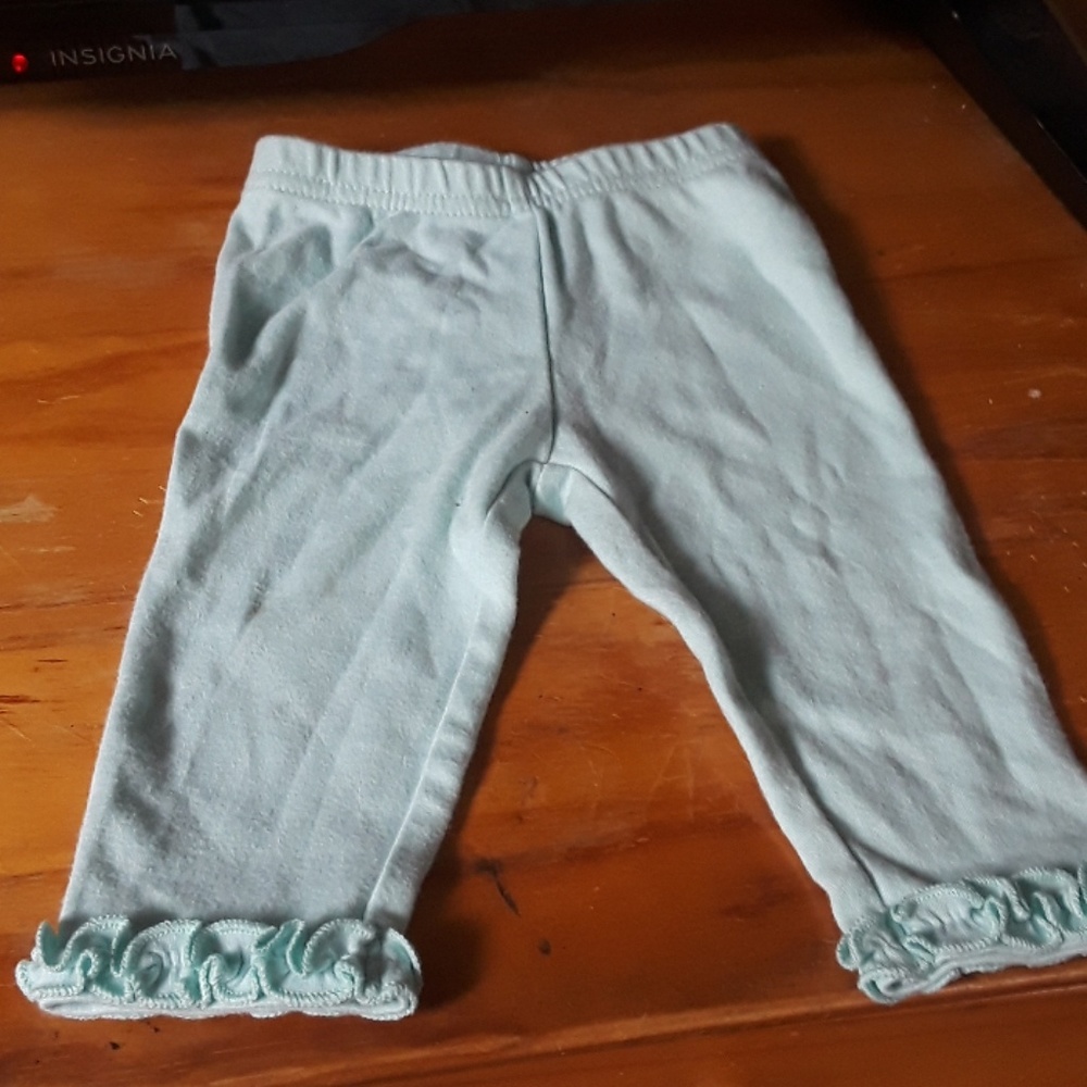 Baby pants with ruffles at the bottom of them